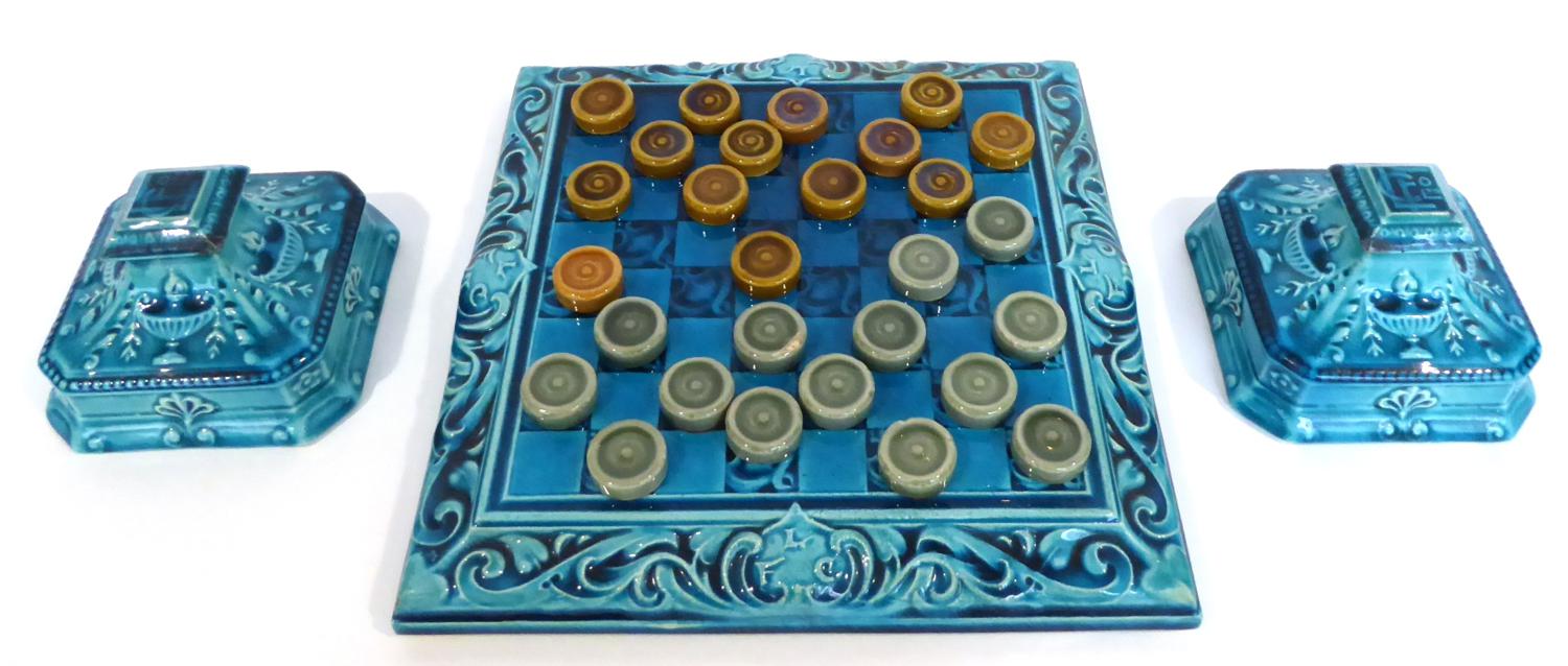 A Leeds Fireclay Co. Ltd Draughts Board and Twenty-Eight Draughts Pieces, the board moulded with