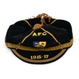 A Blue Velvet and Gilt Thread Sporting Cap, dated 1915-1917 with blue/yellow bee/beehive cloth