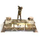 An Early 20th Century Silver Plated Golfing Desk Inkwell, comprising a figure of a golfer flanked by