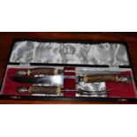 A cased Dunhill antler handled three piece carving set