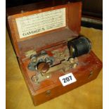 A Gamages Morse Key with light in mahogany box