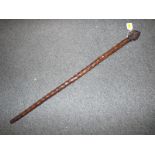 A period walking cane with heavily knott