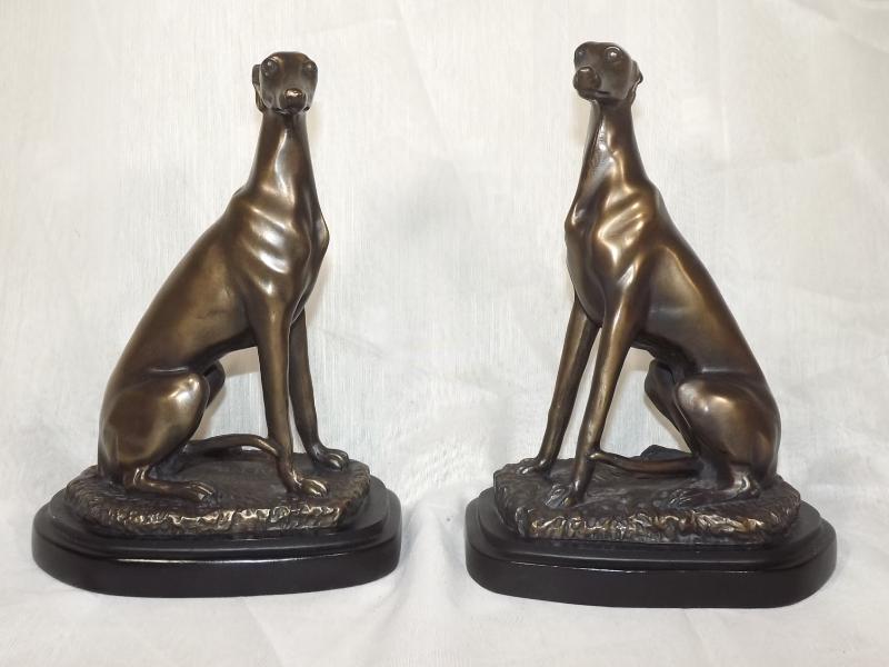 A pair of bronzed figurines depicting gr