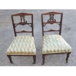 A pair of Edwardian low chairs with carv