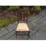 An Edwardian chair with upholstered seat