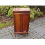 A good quality mahogany music cabinet on