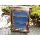 A credenza, the glazed front opening to