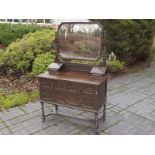 A mirror back oak dressing table on barl