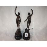 A pair of bronzed figures mounted on pli