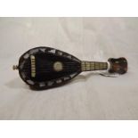 A miniature banjo of tortoise shell with