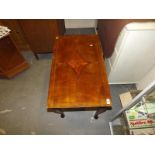 A mahogany coffee table with inlaid patt