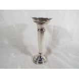 A hallmarked silver loaded trumpet vase,