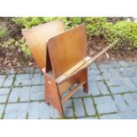 An oak magazine rack with brass handle,