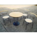 A circular kitchen table and four kitche