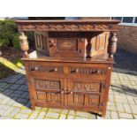 A carved oak court cabinet 139cm (h) x 1