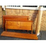 A sleigh style pine double bed