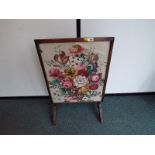 A fire screen tapestry which converts to