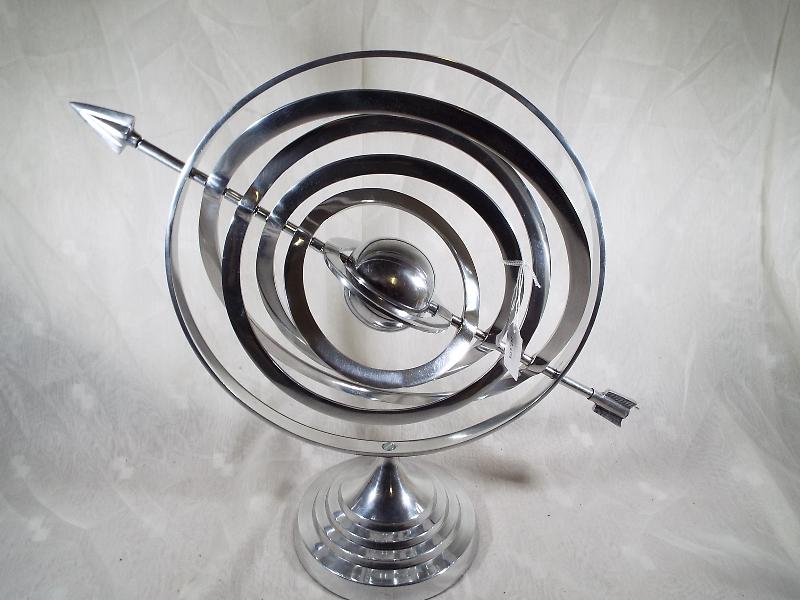 A white metal gyroscope 44cm (h)