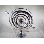 A white metal gyroscope 44cm (h)