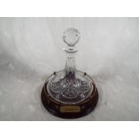 A good quality ship's decanter on wooden