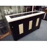 A wooden and marble sideboard with three