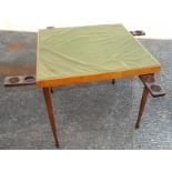 A card table, with folding legs and drin