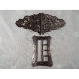 A Victorian silver buckle with relief sc