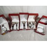 Five heavy duty watch cases containing seven good quality white metal wrist watches predominantly