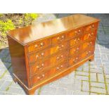 A large mahogany chest of 9 drawers on b