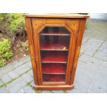 A small mahogany cabinet with inlaid mar