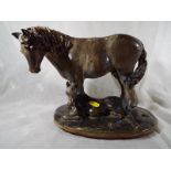 A stoneware sculpture depicting a mare a