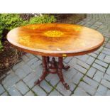 A Victorian mahogany, with inlaid decoration, oval occasional table on a carved pedestal and four