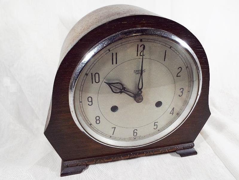 An oak cased mantel clock Arabic numeral