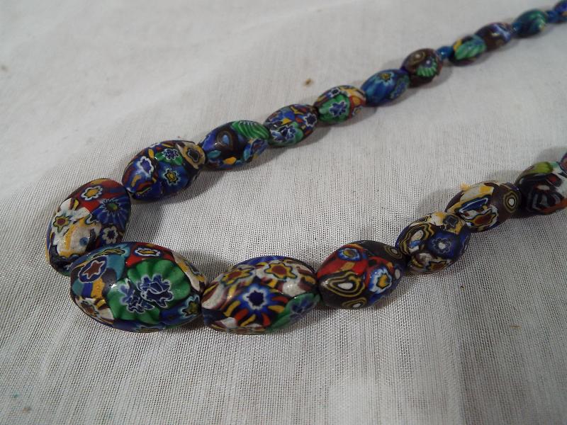 A heavy single strand beaded necklace, decorated with an intertwined millefiori design, - Image 2 of 2