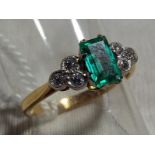 A lady's 14 carat gold and platinum ring, with diamond set in trefoil formation and emerald,