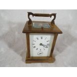 A brass cased carriage clock - lot description to follow