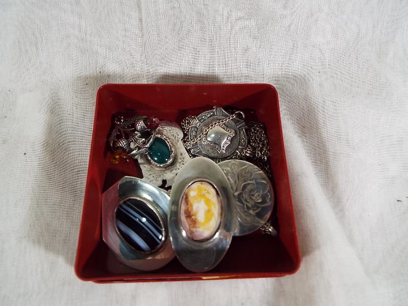 A small collection of hallmarked silver and sterling silver pendants and brooches, part stone-set