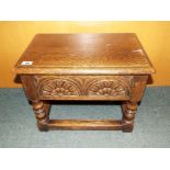 An oak side table with hinged top lid and turned supports, 37cm (h) x 48cm (w) x 32cm (d)