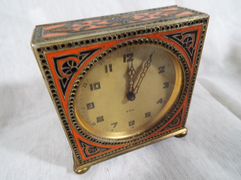 A desk timepiece, the brass case having black and orange enamelling, champagne dial marked 8 day, - Image 2 of 4