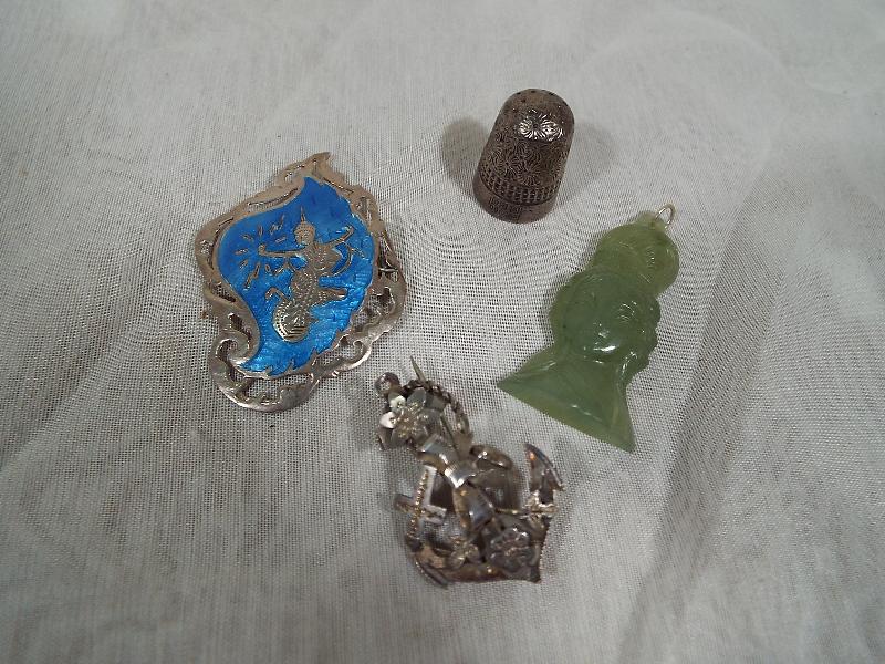 A Eastern style enameled silver brooch, a hard stone pendant, an hallmarked silver brooch in the