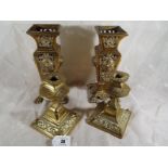 A pair of brass candlesticks with relief foliate decoration, 16cm (h) and two brass vases with