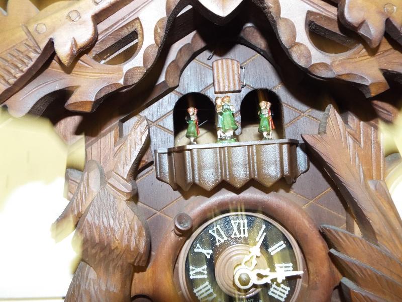 A decorative wall mounted cuckoo clock, two pine cone weights, carved animals to case and top - Image 2 of 2
