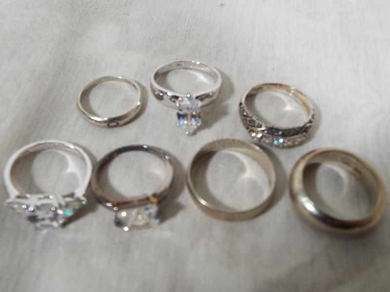 A collection of seven silver rings to include to wedding bands