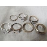 A collection of seven silver rings to include to wedding bands