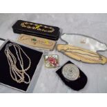A Stratton powder compact, a small compact mirror and a collection of pearl necklaces and similar