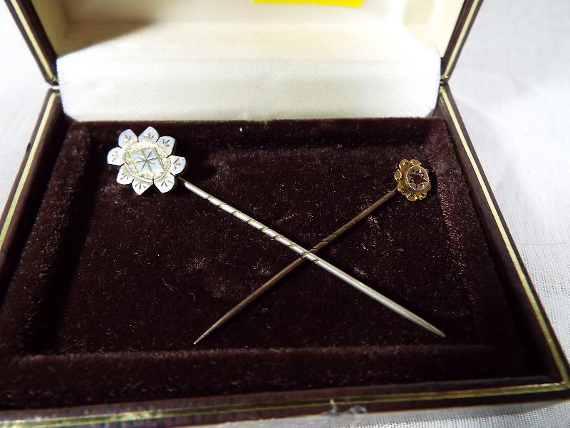 A lady's 9ct gold hallmarked tie pin, set with ruby and one other of white metal (2)
