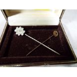 A lady's 9ct gold hallmarked tie pin, set with ruby and one other of white metal (2)