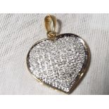 A lady's stone encrusted heart shaped pendant with gold mounts stamped 9k. with 1 k diamonds