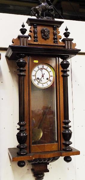 An early 20th century Vienna style wall clock, the mahogany case with turned decoration surmounted