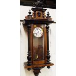 An early 20th century Vienna style wall clock, the mahogany case with turned decoration surmounted